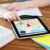 close up of student with tablet pc and notebook