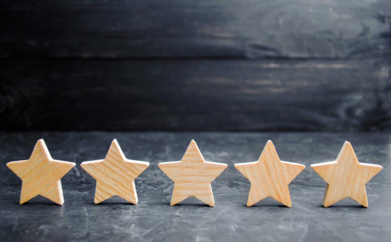 Five wooden stars. Get the fifth star. The concept of the rating of hotels and restaurants, the evaluation of critics and visitors. Quality level, good service. selective focus