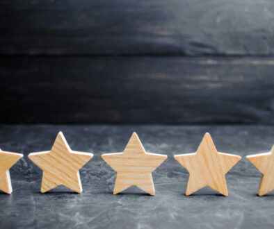 Five wooden stars. Get the fifth star. The concept of the rating of hotels and restaurants, the evaluation of critics and visitors. Quality level, good service. selective focus
