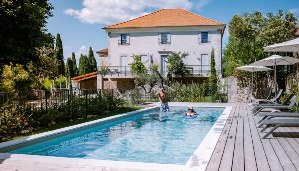 people-by-swimming-pool-against-built-structure_0x800