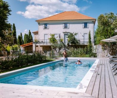 people-by-swimming-pool-against-built-structure_0x800
