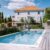 people-by-swimming-pool-against-built-structure_0x800