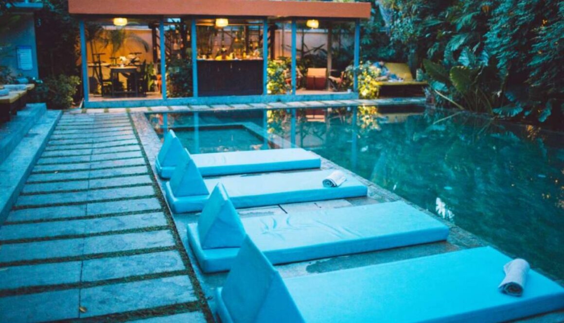 lounge-chairs-by-swimming-pool-against-building_0x800