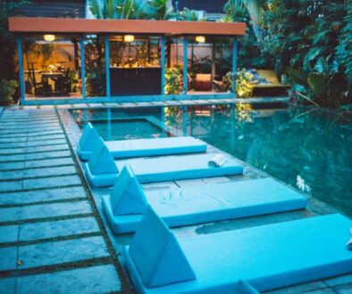 lounge-chairs-by-swimming-pool-against-building_0x800