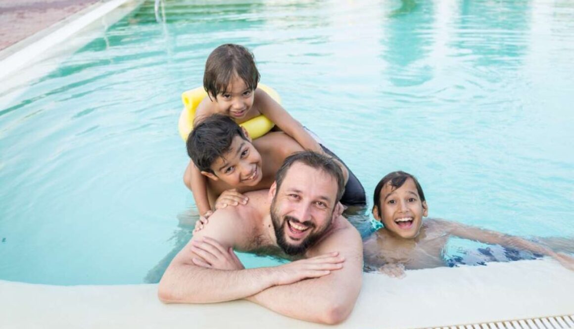 young-boy-kid-child-splashing-swimming-pool-having-fun-leisure-activity_0x800